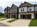 New townhomes feature brick and siding exteriors, two-car garages, and manicured lawn strips at 3104 Marbella Cir # 2, Kennesaw, GA 30152