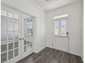 Bright foyer with glass french doors and wood flooring for a modern and elegant look at 1147 Trident Maple Chase, Lawrenceville, GA 30045