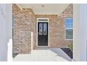 Close-up of the front door of the house, showing the brick facade at 1147 Trident Maple Chase, Lawrenceville, GA 30045