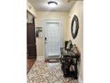 Inviting entryway featuring decorative tile flooring, elegant mirror, and stylish console table at 133 Titan Rd, Stockbridge, GA 30281