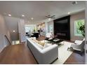 Open-concept living room with a sleek fireplace, modern furniture, and hardwood floors at 1923 Cassia Aly, Kennesaw, GA 30144