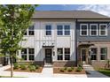 Charming townhome with brick and white siding, lush landscaping, and inviting entryways at 341 Skylar Se Way, Atlanta, GA 30315