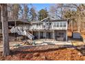 Backyard patio with firepit, hot tub, and hammock in the backyard of this lake house at 405 Miller Rd, Covington, GA 30014