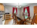 Elegant dining room with hardwood floors, a chandelier, and large windows at 1145 Arbordale Dr, Decatur, GA 30033