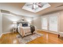 Serene bedroom with a skylight, hardwood floors, and French doors to a patio, creating a peaceful retreat at 1145 Arbordale Dr, Decatur, GA 30033