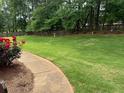 Enjoy a large, fenced backyard with lush green grass and a charming patio area at 240 Huiet Dr, Mcdonough, GA 30252