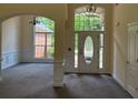 Inviting foyer with elegant chandelier and beautiful natural light from large windows at 240 Huiet Dr, Mcdonough, GA 30252