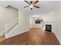 Open floor plan with hardwood floors, fireplace, stairs and view of the kitchen at 274 Paden Cove Trl, Lawrenceville, GA 30044
