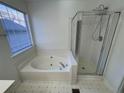 Bathroom featuring a soaking tub next to a separate glass enclosed shower at 2887 Royal Blf, Decatur, GA 30030