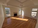 Bright living room with hardwood floors, a fireplace, and large windows offering natural light at 2887 Royal Blf, Decatur, GA 30030