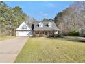 Charming single-story home with brick and siding exterior, well-manicured lawn, and attached garage at 950 Besse Way, Locust Grove, GA 30248