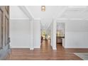 Bright foyer with hardwood floors, white trim, and coffered ceilings offering a glimpse into the home's open layout at 4720 Cooling Water Sw Cir, Powder Springs, GA 30127