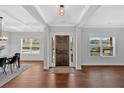 Entryway showcasing hardwood floors, a dark wood door, and large windows providing ample natural light at 4720 Cooling Water Sw Cir, Powder Springs, GA 30127