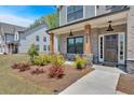Inviting front porch with brick pillars, a stone foundation, and dark wood door welcomes you to this beautiful home at 4720 Cooling Water Sw Cir, Powder Springs, GA 30127
