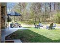 Relaxing backyard with patio, fire pit, and Adirondack chairs, perfect for outdoor entertaining at 5925 Old Bill Cook Rd, South Fulton, GA 30349