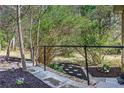 Landscaped garden with stone pathway, mulch, and flourishing plants, complemented by a black railing at 5925 Old Bill Cook Rd, South Fulton, GA 30349