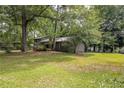 Charming gray home is surrounded by lush greenery and mature trees at 633 Iris Rd, Pine Lake, GA 30072