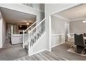 Inviting foyer with a staircase, neutral color palette, and views into the living and dining areas at 9744 Musket Ridge Cir, Jonesboro, GA 30238