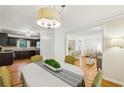 Dining room featuring hardwood floors, a stylish chandelier, and an open floor plan at 2381 Woodacres Rd, Atlanta, GA 30345