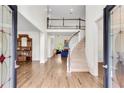Elegant foyer showcasing gleaming hardwood floors, a curved staircase, and a view into the spacious living area at 3106 Soldier Trl, Marietta, GA 30068