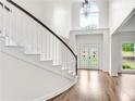 Light filled foyer highlighting hardwood floors, a curved staircase, and a large window at 3106 Soldier Trl, Marietta, GA 30068