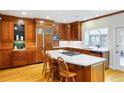 Spacious kitchen with custom wood cabinetry, stainless steel appliances, and center island with cooktop at 3358 Stovehill Se Ct, Marietta, GA 30067