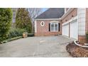 Spacious two-car garage with a concrete driveway and brick exterior at 5560 Stoneleigh Dr, Suwanee, GA 30024