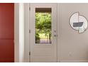 Modern white front door with a glass insert, offering a view of the green and vibrant outdoors at 720 Maynard Se Ter, Atlanta, GA 30316