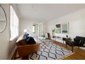 Bright living room with hardwood floors, modern furniture, a stylish rug, and natural light from the windows at 720 Maynard Se Ter, Atlanta, GA 30316