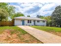 Beautiful single-story home with a long driveway, white exterior and well-maintained lawn at 1755 Rockbridge Nw Rd, Conyers, GA 30012