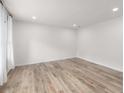 Bright, open living room featuring new hardwood flooring and recessed lighting at 1755 Rockbridge Nw Rd, Conyers, GA 30012