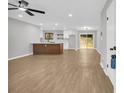 Open-concept living room features wood floors, modern lighting, and a kitchen with a breakfast bar at 1829 Herringbone Holw, Lithonia, GA 30058