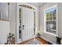 Inviting entryway featuring a white door with sidelights and transom window allowing for plenty of natural light at 3025 Woodwalk Se Dr # 17, Atlanta, GA 30339