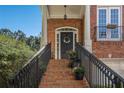 Brick front porch with wrought iron railing and columned entry evokes old world Southern Charm at 3025 Woodwalk Se Dr # 17, Atlanta, GA 30339