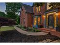 Brick home with a blue-trimmed entryway and a meticulously landscaped front yard at 5010 Winding Hills Ln, Woodstock, GA 30189