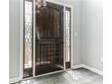 Elegant wooden front door with sidelights, offering a glimpse of the outdoors at 5452 Sweetsprings, Powder Springs, GA 30127