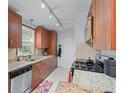 Well-equipped kitchen featuring granite countertops, stainless steel appliances, and dark wood cabinetry at 732 S Fairfield Dr, Peachtree City, GA 30269