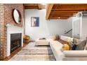 Living room with fireplace, exposed brick, wood floors, modern furniture, and art at 320 Martin Luther King Jr Se Dr # 15, Atlanta, GA 30312