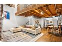 Open-concept living space with wood floors, exposed ceiling beams, modern furniture, and art at 320 Martin Luther King Jr Se Dr # 15, Atlanta, GA 30312