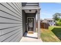 Inviting front entrance featuring gray siding and a charming welcome mat at 3406 Pennington Dr, Lithonia, GA 30038