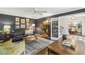 Elegant living room with dark blue walls, leather sofa, decorative pictures, and hardwood floors at 410 Dalrymple Ne Rd, Atlanta, GA 30328