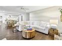 Bright living room featuring a large white sectional, hardwood floors, and modern decor at 410 Dalrymple Ne Rd, Atlanta, GA 30328