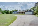 Inviting single-story home features a spacious front yard and convenient driveway at 203 Leigh Dr, Ellenwood, GA 30294