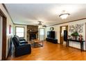 Cozy living room features a stone fireplace, hardwood floors, and ample natural light at 203 Leigh Dr, Ellenwood, GA 30294