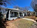 Charming gray home with a inviting front porch and manicured landscaping at 455 Lynch Nw Ave, Atlanta, GA 30318