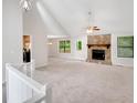 Spacious living room with vaulted ceilings, stone fireplace, neutral carpet and paint at 4788 Rock Island Nw Ln, Acworth, GA 30102