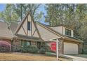 Inviting Tudor-style home with a brick facade, a well-maintained lawn, and a prominent 'For Sale' sign at 12 Westchester Square Sq, Decatur, GA 30030