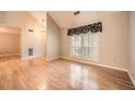 Light-filled living room with wood floors, a large window, and a high ceiling at 12 Westchester Square Sq, Decatur, GA 30030