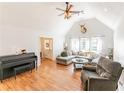 Bright living room features vaulted ceilings, wood floors, a cozy gray couch, and a decorative deer head mount at 150 Newton Ridge Dr, Covington, GA 30014