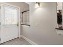 Bright entryway with tile flooring, a white door with sidelight, and classic wall sconce at 1634 Ponce De Leon Ave # 107, Atlanta, GA 30307